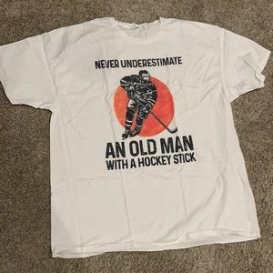 Never underestimate an old man with a hockey stick men’s graphic shirt